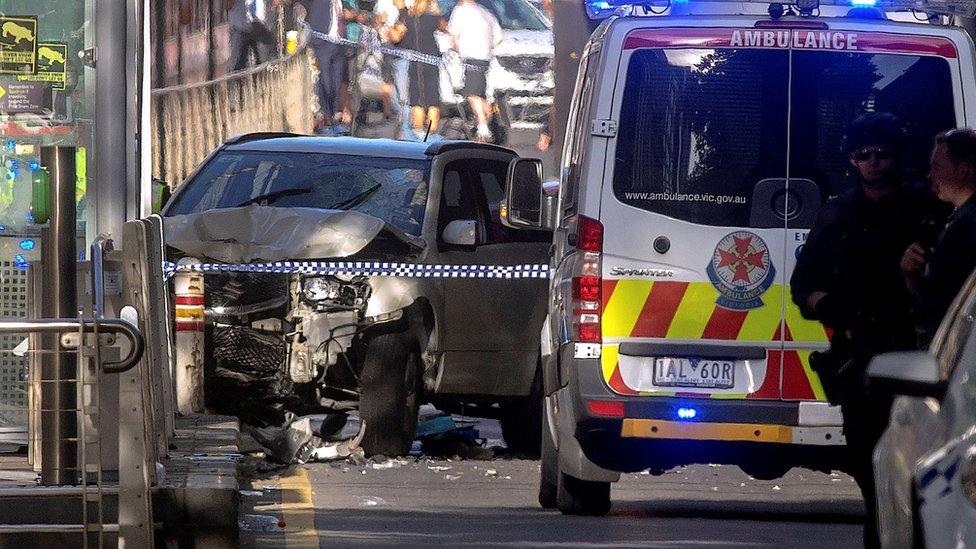 Australian police stand near a crashed vehicle that had ploughed into pedestrians near Flinders Street train station in central Melbourne, Australia, December 21, 2017