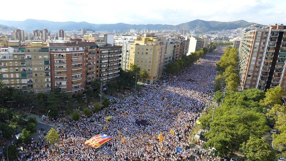 Demonstrators gather on Meridiana street as they wave "Estelada" flags (pro-independence Catalan flags) during celebrations of Catalonia"s National Day (Diada)