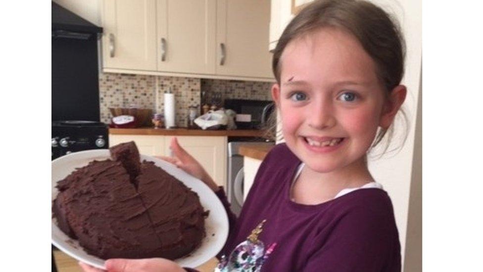 girl-holding-up-chocolate-cake.