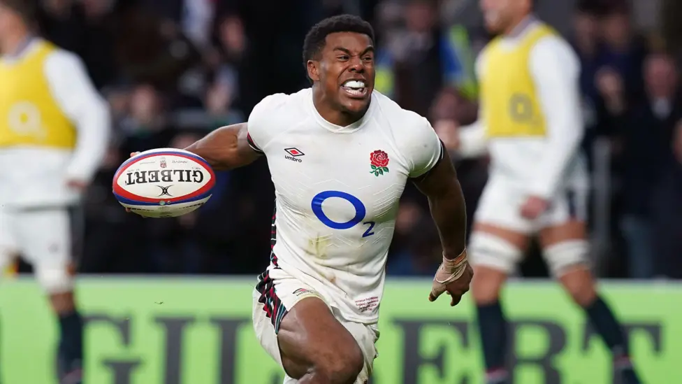 England wing Immanuel Feyi-Waboso celebrating with the ball in his right hand