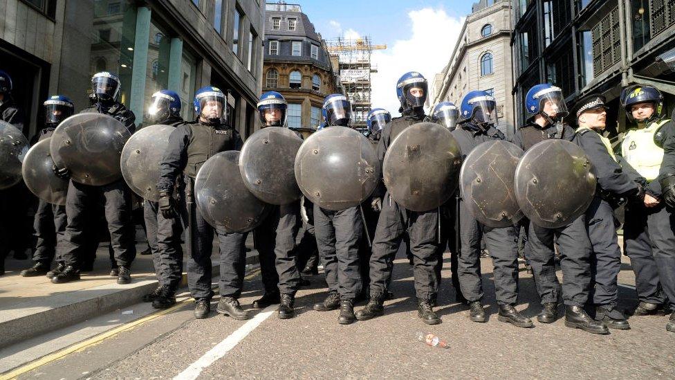 Police holding shields at the 2009 London G20 protests