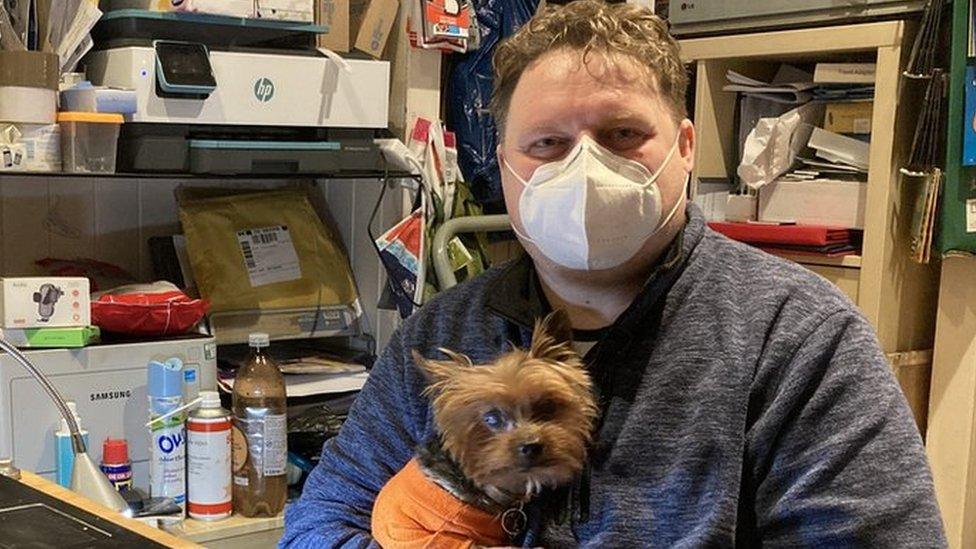 Mark Kelly and his support dog Gizmo - he now runs a mobile phone repair and accessory shop in Neath Market.