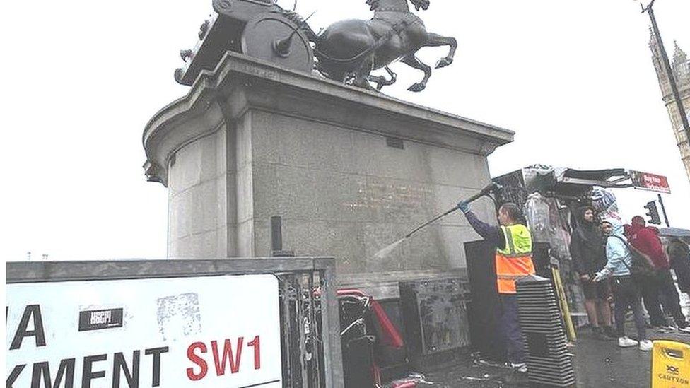 Man cleaning statue