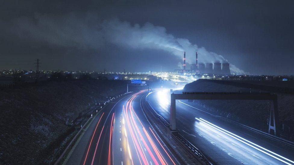 Road with factory in the distance.