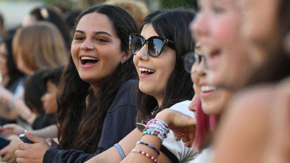 Fans gather outside the "Taylor Swift: The Eras Tour" concert movie world premiere at AMC The Grove in Los Angeles