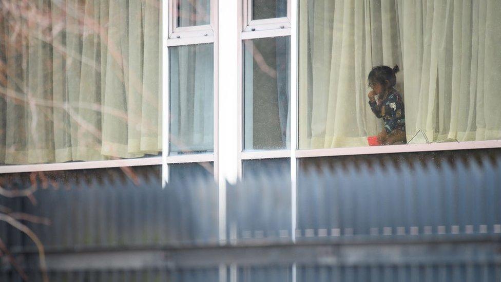 child at hotel window