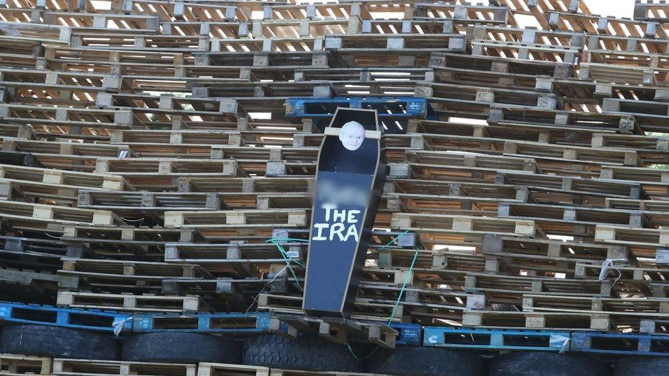 A replica casket with a picture of the former deputy first minister Martin McGuinness hung on a bonfire in east Belfast