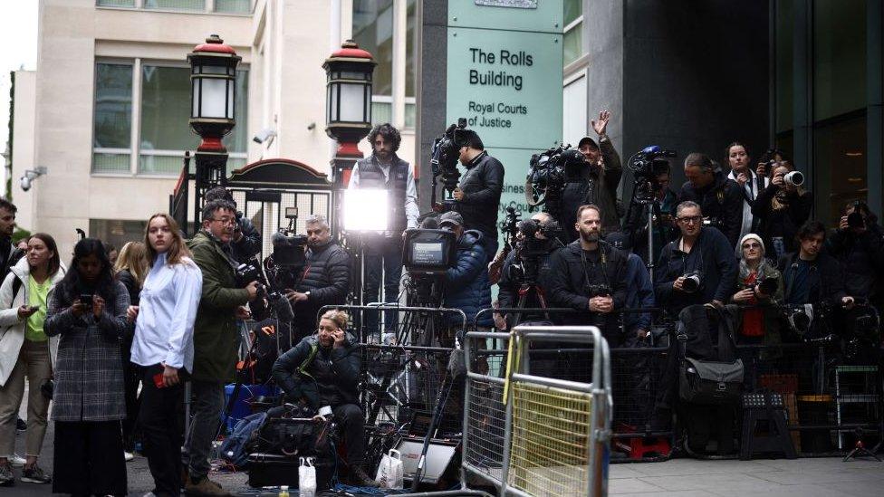 Journalists waiting with cameras outside Rolls Building in London