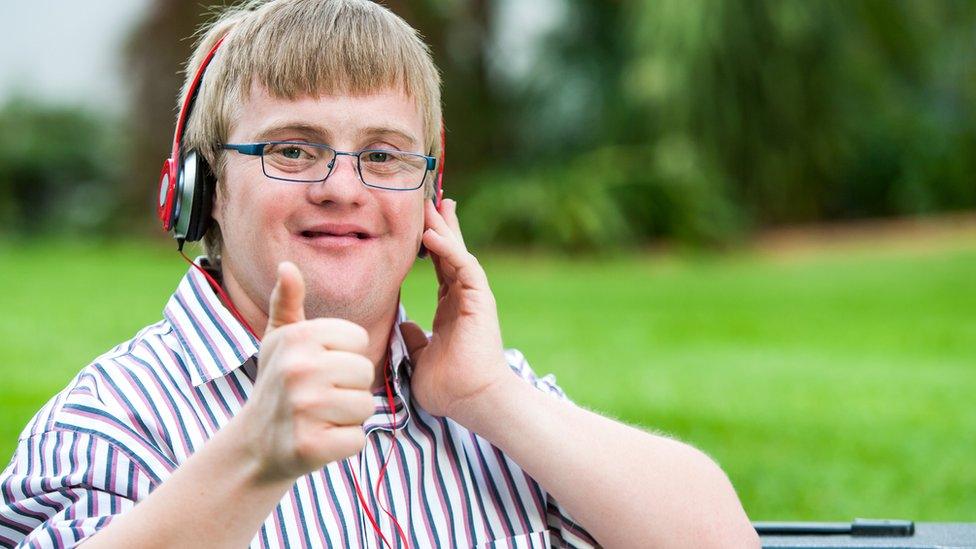 Boy, who has Down's syndrome, listening to music