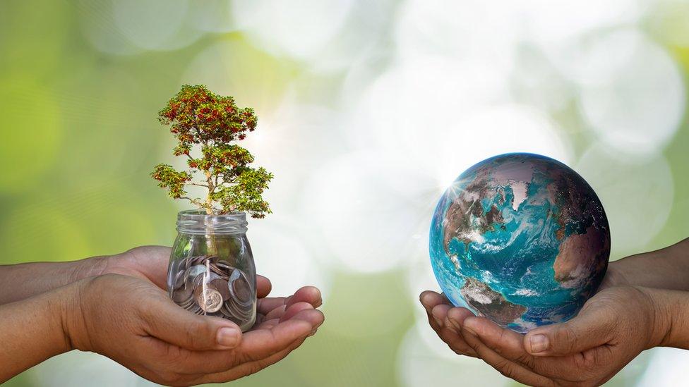 jar-of-money-and-hands-holding-earth