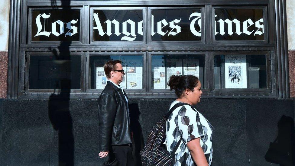 People walking past LA Times building in LA