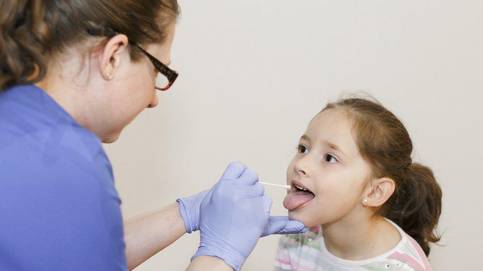 Nurse doing Covid test on child