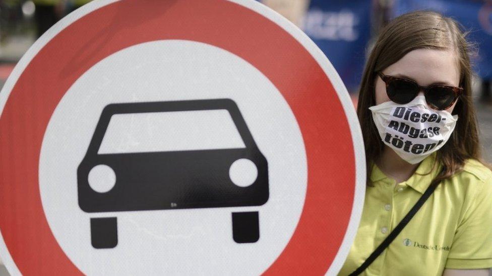 Protester in Germany wears a mask that reads: "Diesel emissions kill"