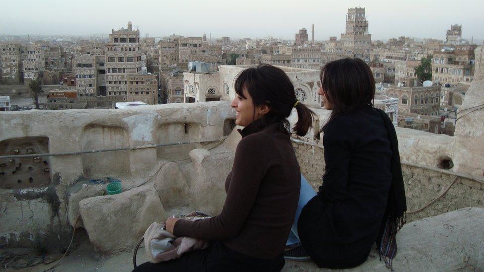 Mai (left) and her sister look out across the Sanaa skyline in 2009