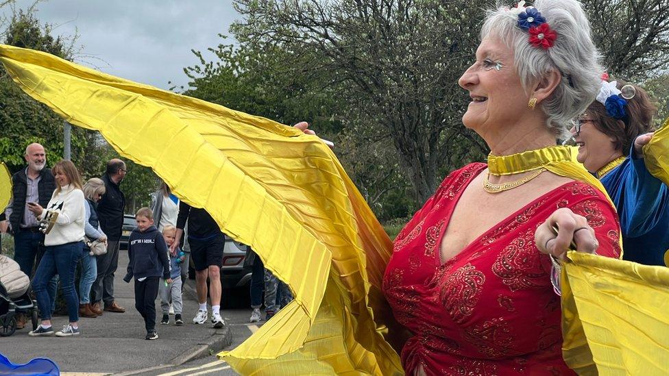 Belly dancer walking on the street