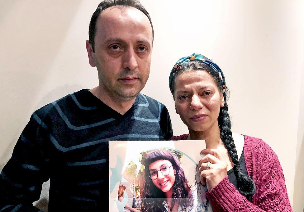 Yaren's parents hold a poster of the student, detained last month in Istanbul