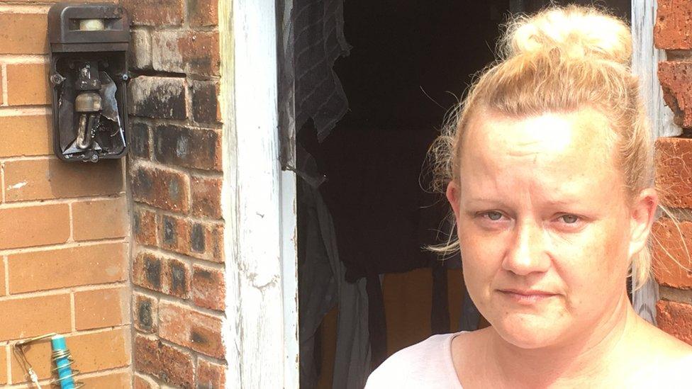 Donna Curley pictured next to a light on her house that was damaged by the lightning