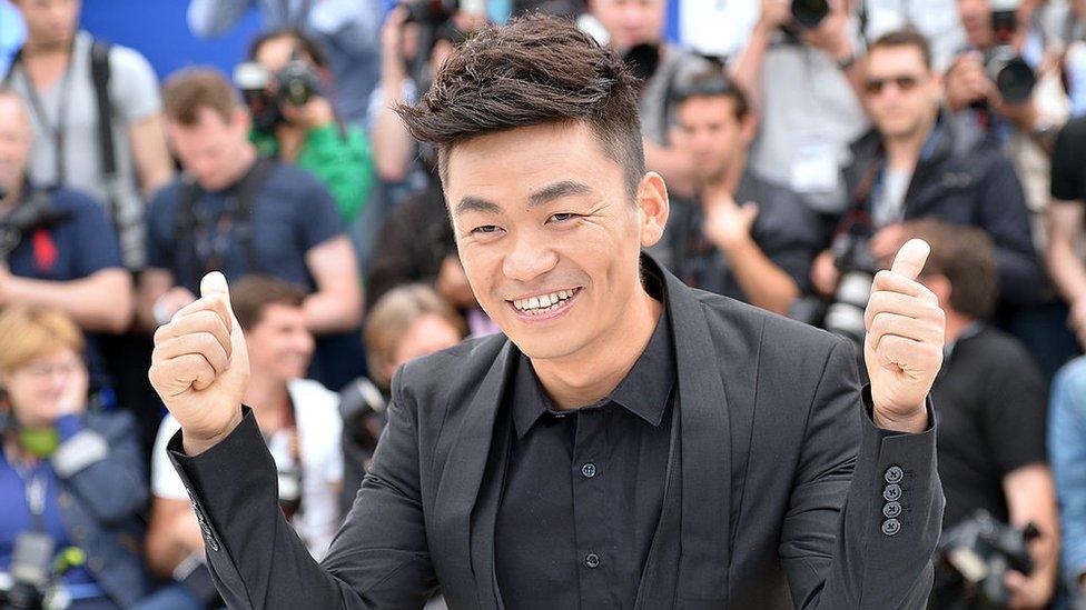 Chinese actor Wang Baoqiang gives thumbs-up on May 17, 2013 while posing during a photocall for the film 'Tian Zhu Ding'