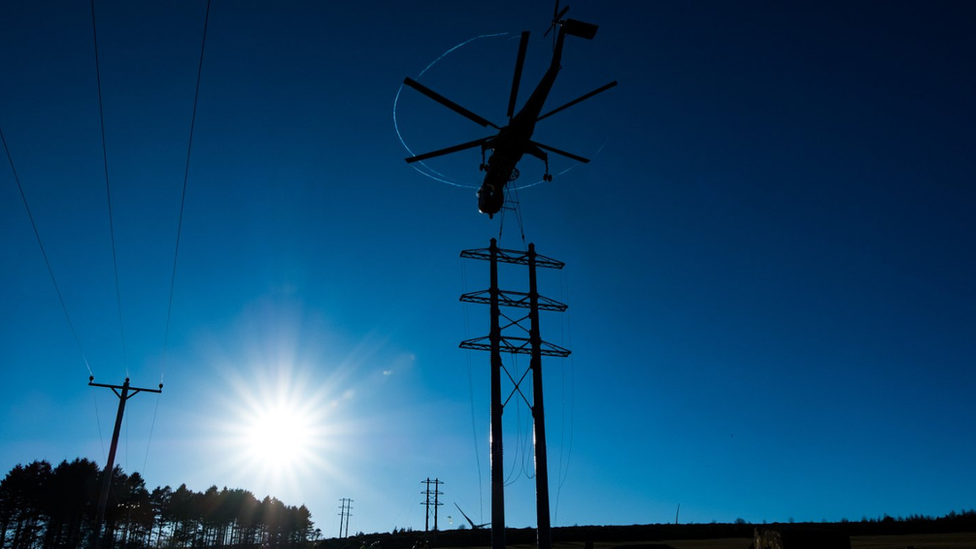 Helicopter and electricity towers