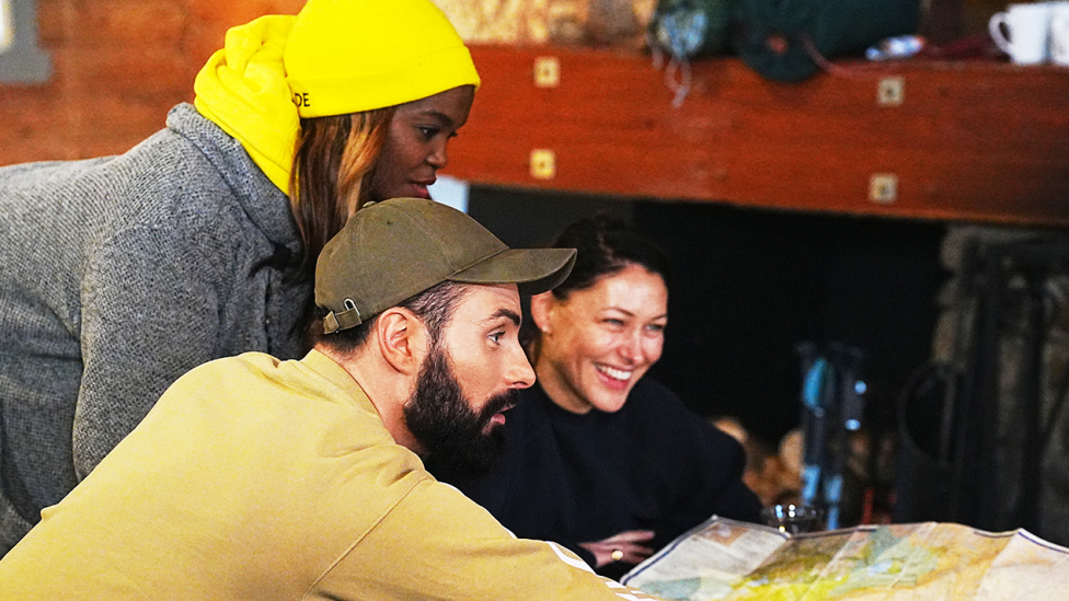 Left to right: Oti, Rylan and Emma study a map