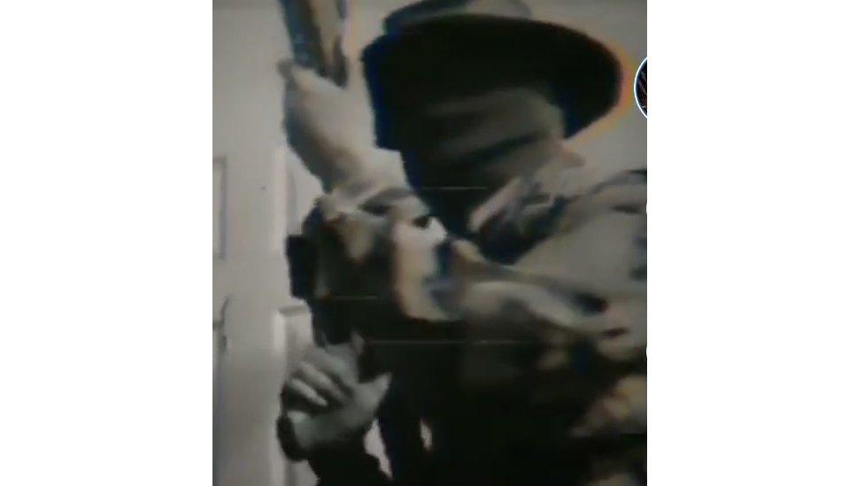 Screengrab from Tiktok showing a man with a large gun and using a Boogaloo hashtag