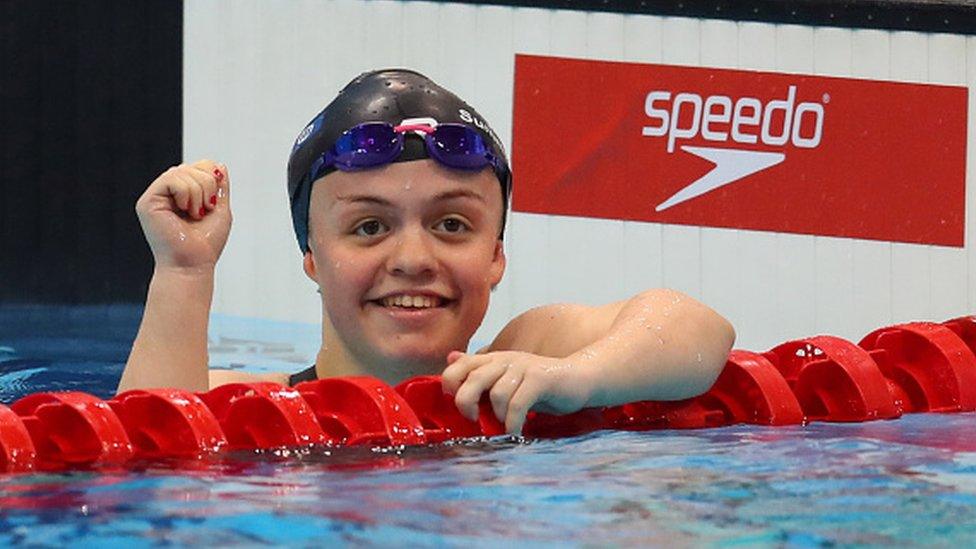 Maisie celebrating in the water