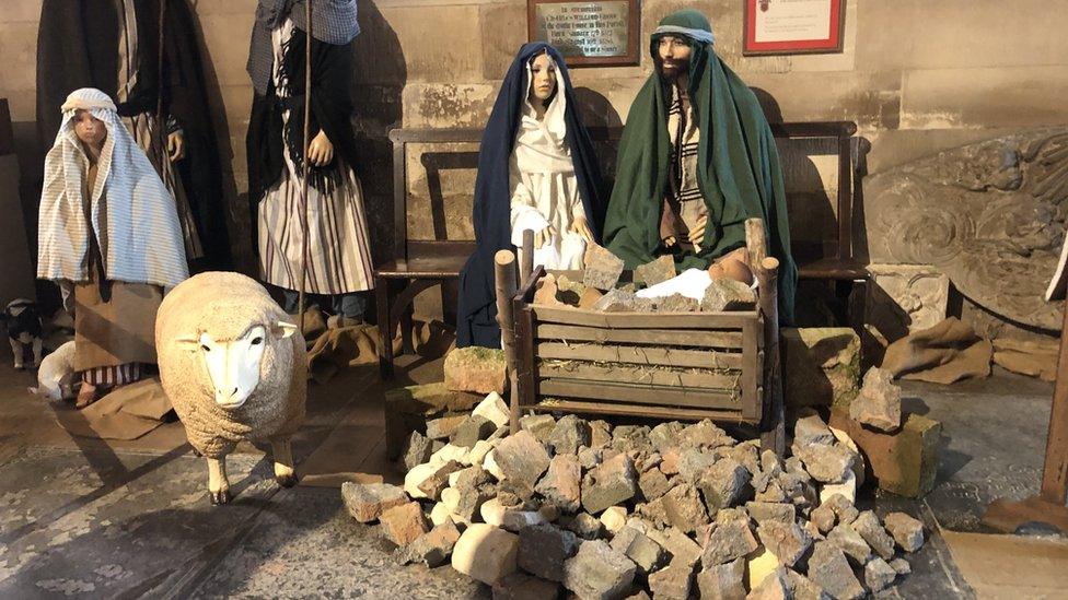 Crib scene surrounded by rubble