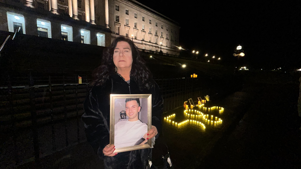 Lorraine Brennan holding a photo of her son