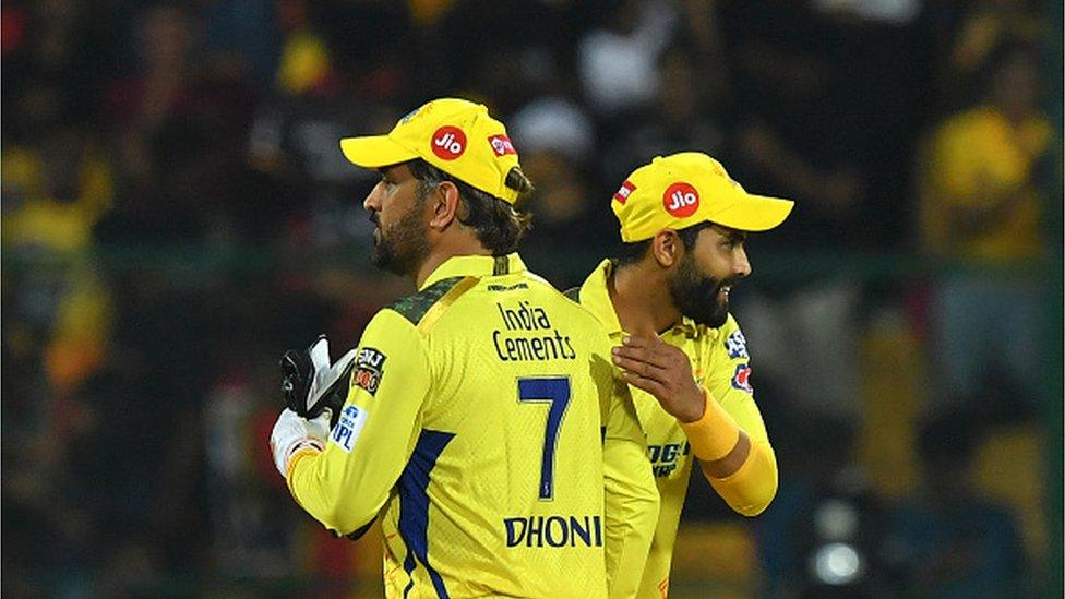 Chennai Super Kings' Mahendra Singh Dhoni greet Ravindra Jadeja after winning the Indian Premier League (IPL) Twenty20 cricket match between Royal Challengers Bangalore and Chennai Super Kings at the M Chinnaswamy Stadium in Bengaluru on April 17, 2023. (