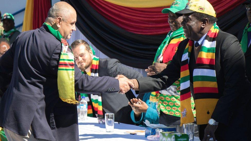 Zanu-PF candidate greets people at a rally in Harare attended by white farmers and members of the business community