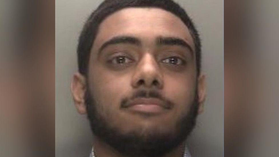 A mugshot of Shaan Farooq, showing his face and neck. He is in front of a grey background.