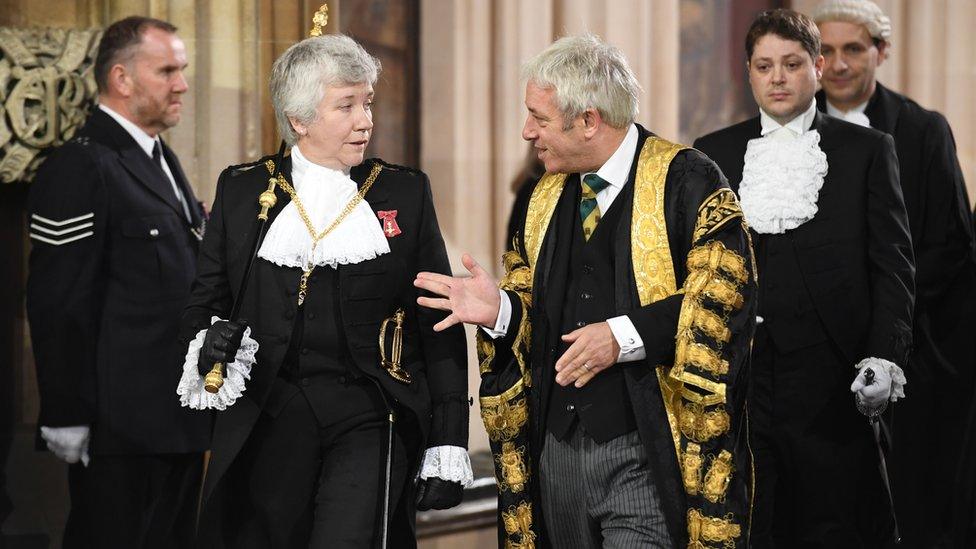 Officials in formal black and gold dress