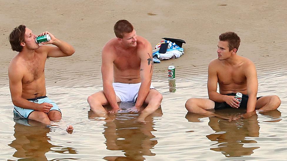 Men sitting in the sea