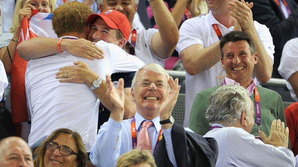 John Major (centre) pictured with Seb Coe (right) and Peter Phillips hugging Prince Harry (left) at the Velodrome in London 2012