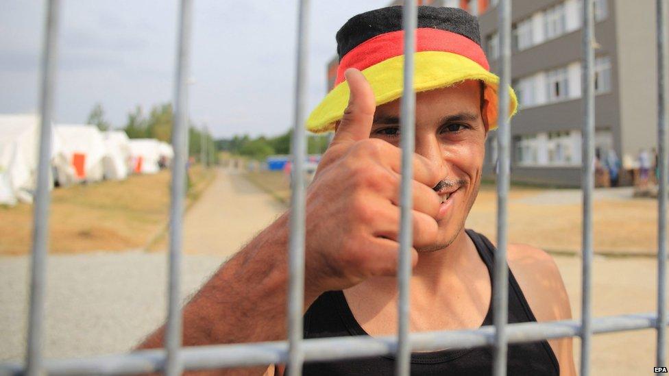 22-year-old Ali from Aleppo in Syria gives thumbs-up at the central reception centre for asylum seekers in Halberstadt, Germany (12 August 2015)