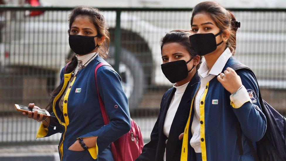 Students wearing protective masks as a precautionary measure following multiple positive cases of Coronavirus in the country