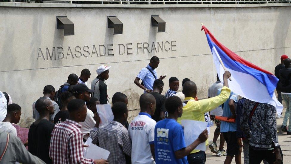 People gather in front of the Embassy of France to protest against French President Emmanuel Macron's visit in Kinshasa, Democratic Republic of Congo on March 01, 2023.