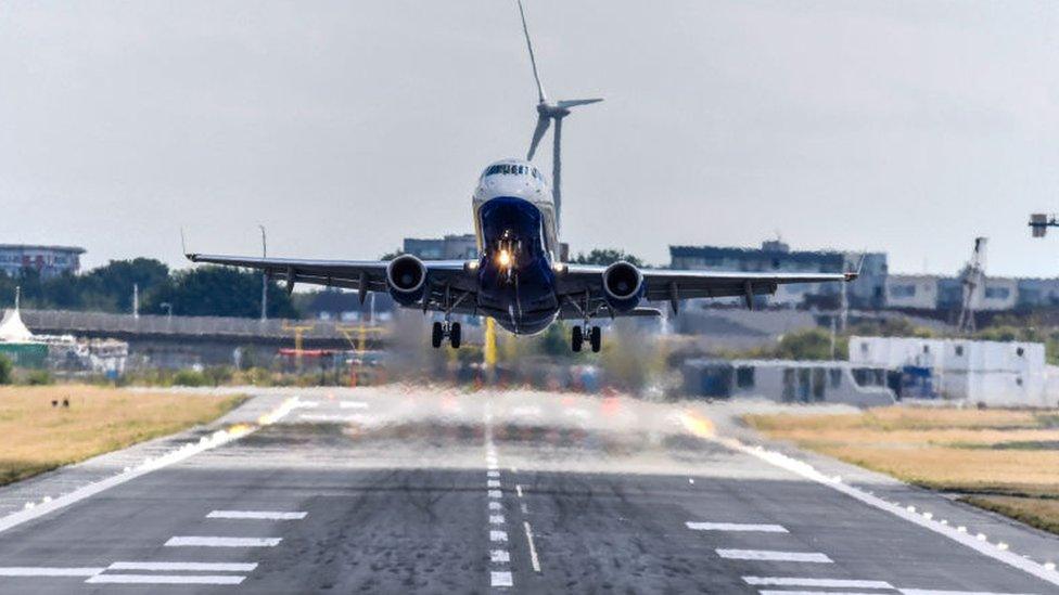 A plane takes off from London City Airport