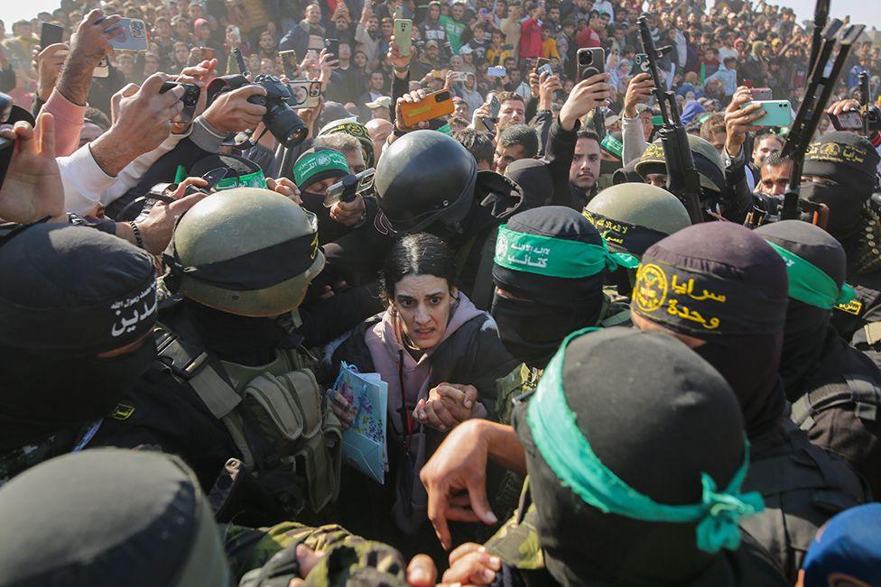 Israeli captive Arbel Yehoud, 29, who has been held hostage by Hamas in Gaza since October 7, 2023, is escorted by Hamas and Islamic Jihad fighters as she is handed over to the Red Cross in Khan Younis, southern Gaza Strip, Thursday Jan. 30, 2025.