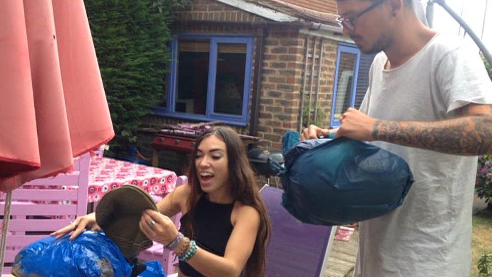 Jaz and Dan sorting donations at home