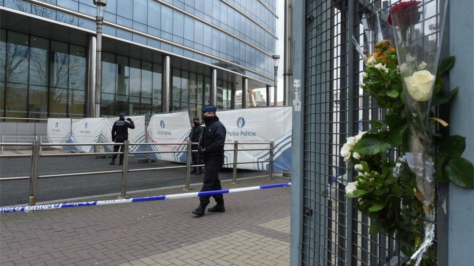 Flowers hang on a fence near the Maelbeek metro station in Brussels