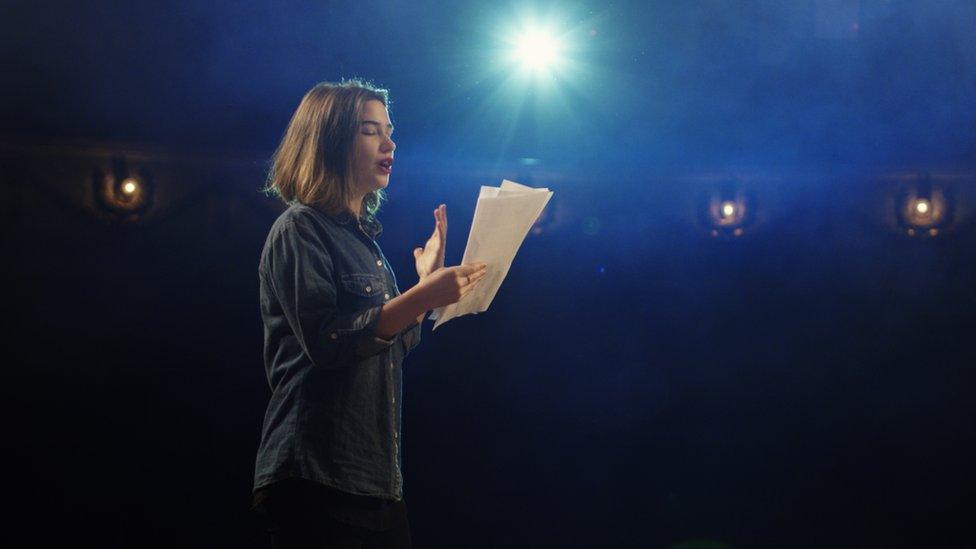 Stock shot of an actress rehearsing in a theatre