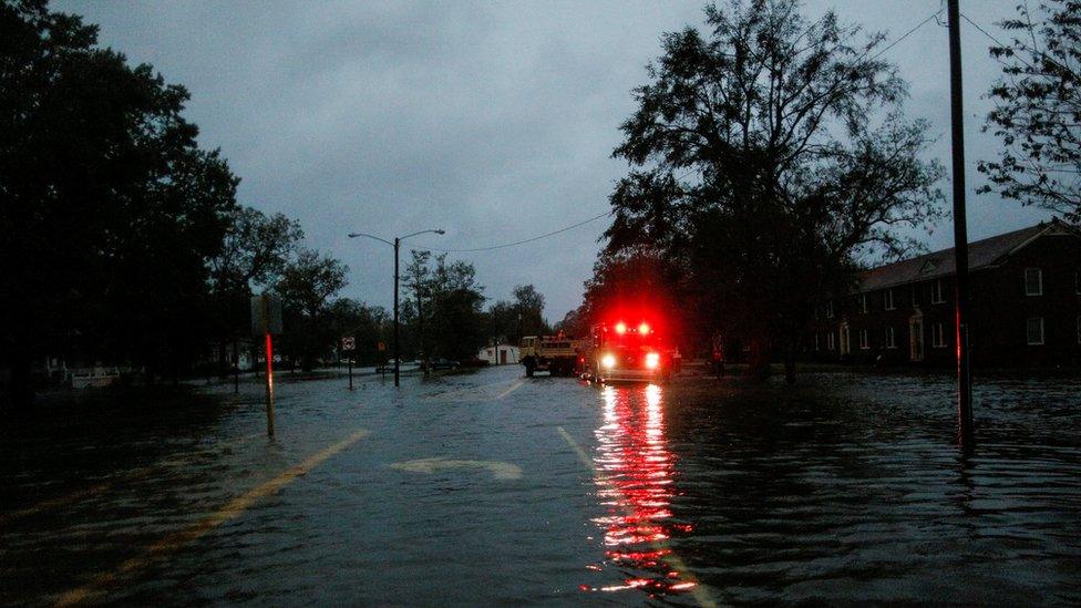 A vehicle in a flooded street in the North Carolina city of New Bern