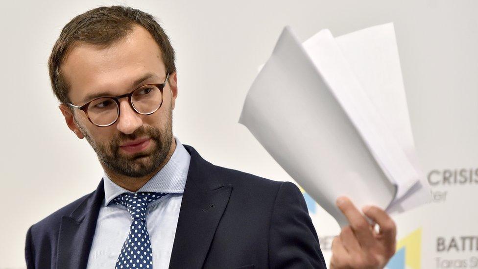 Ukrainian journalist and member of parliament Serhiy Leshchenko holds pages showing allegedly signings of payments to Donald Trump's presidential campaign chairman Paul Manafort from an illegal shadow accounting book of the party of former Ukrainian president Viktor Yanukovych during a press conference in Kiev on August 19, 2016.