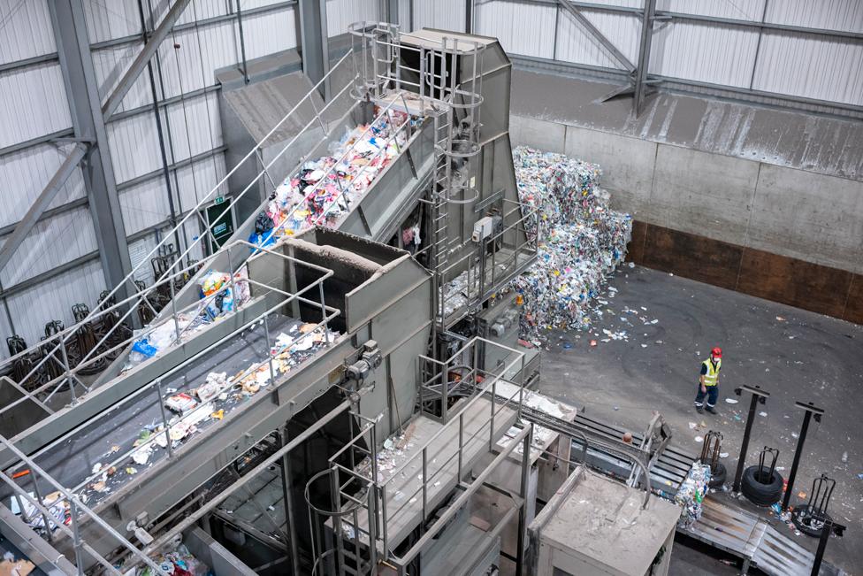 Conveyor belts carrying piles of recycling