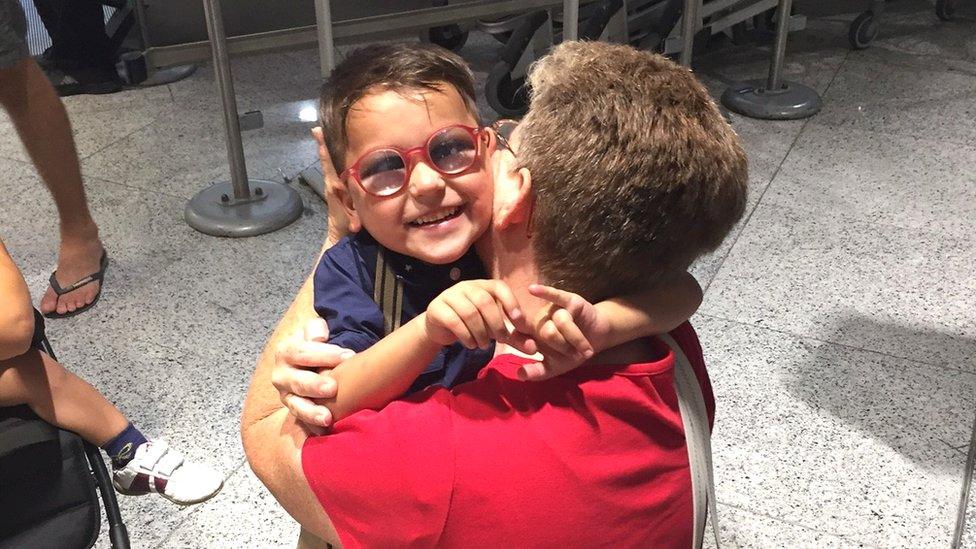 Lisa Campbell hugs Mustafa, a young resident of the camp, as he prepares to leave the camp