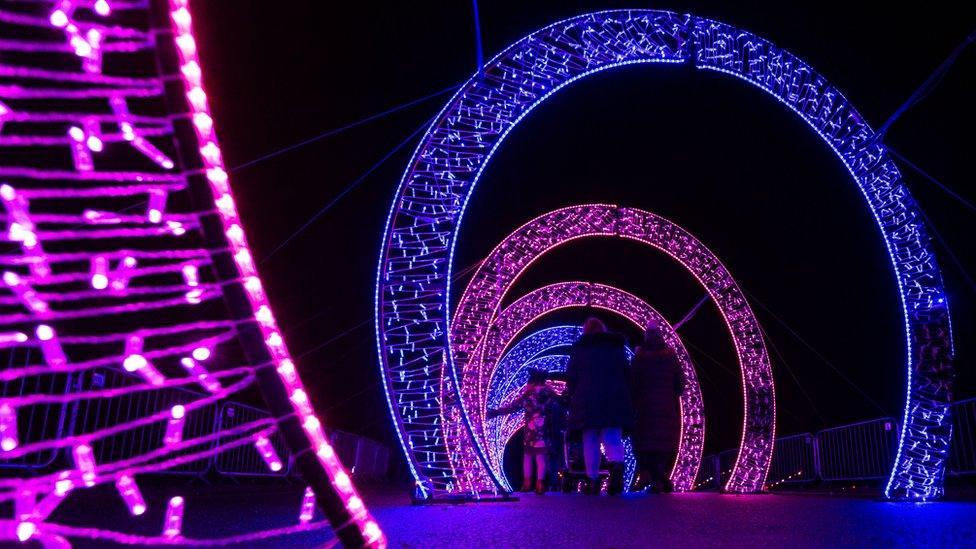 people walk through lightopia