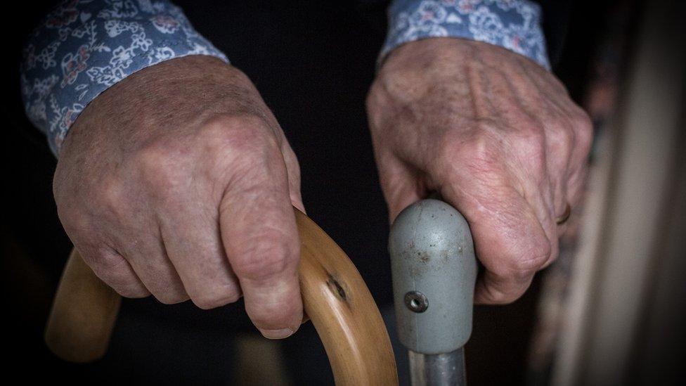 Man holding walking sticks