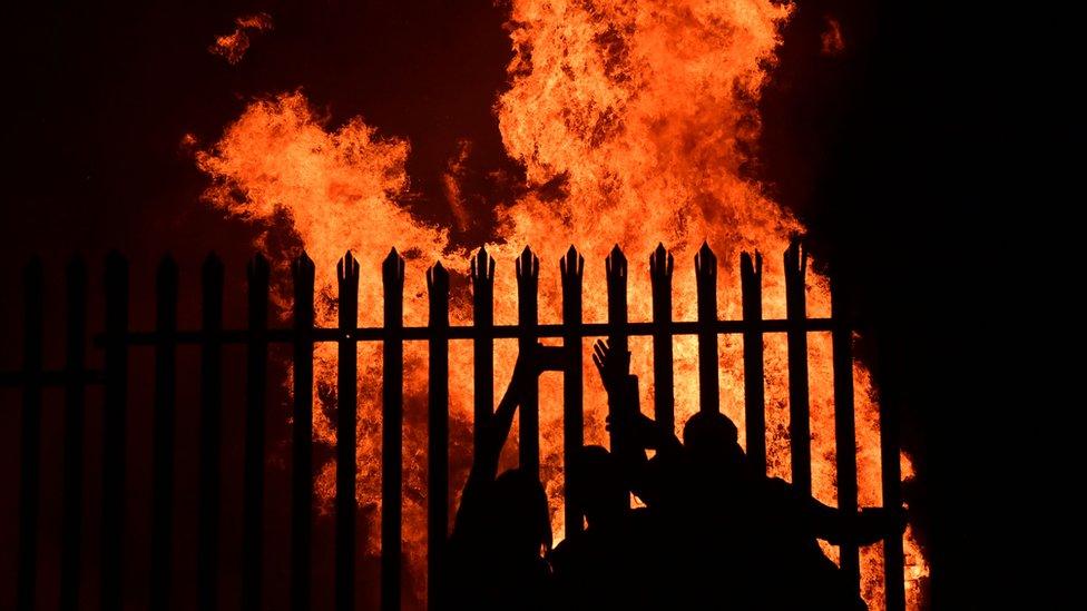 People dancing near an Eleventh night bonfire