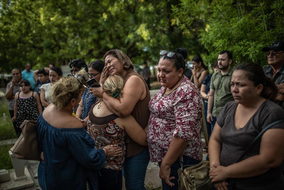 Mirna Nereyda hugs a mother who found the remains of her son four months after he went missing